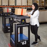 Warehouse staff and robots work hand in hand