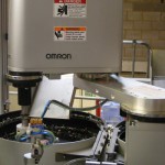 Omron SCARA robot assembles spigots cost effectively