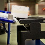 Robots versus conveyors in warehouse logistics