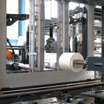 Roll wrapping with robotic mandrel gripper